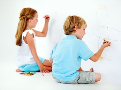 kids drawing crayons on the wall