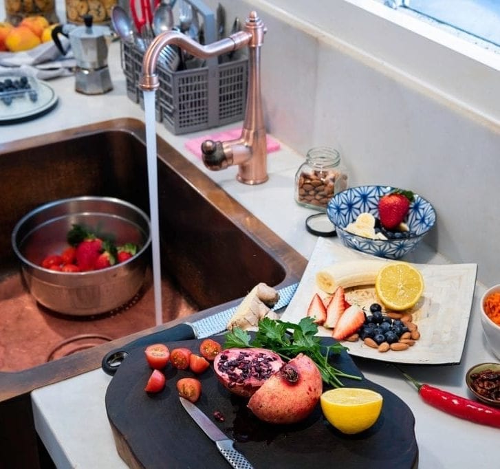 preparing fresh fruits in a copper sink