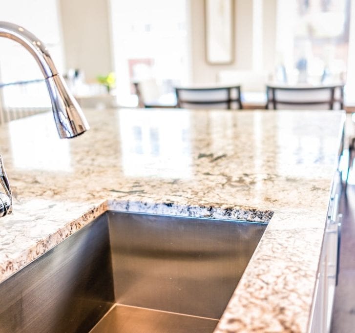 kitchen faucet and sink in granite countertop