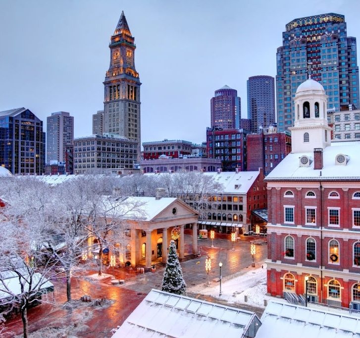 rooftops covered in snow during the winter season in Boston