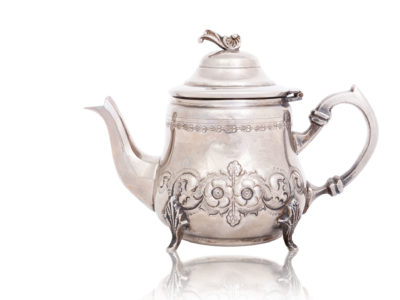 Beautiful shiny teapot on white background