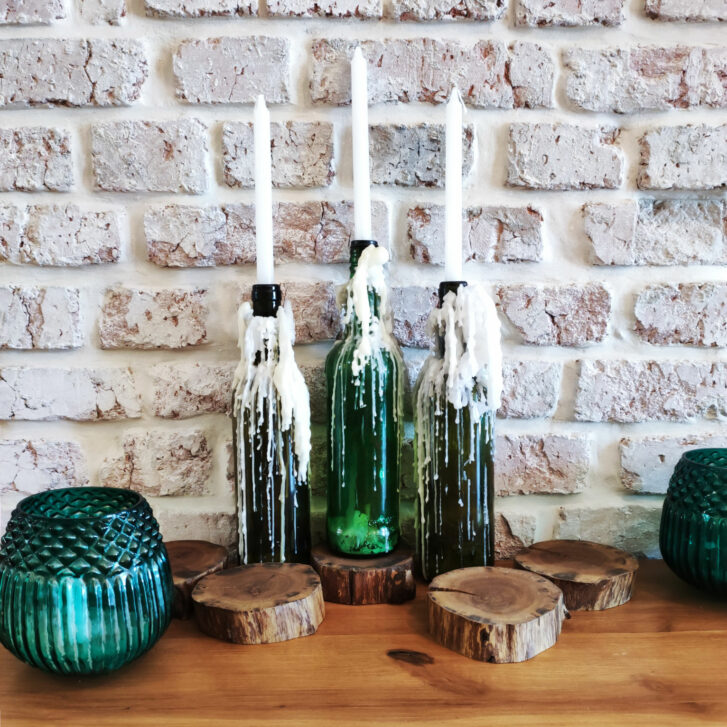 candles in wine bottles used as decor