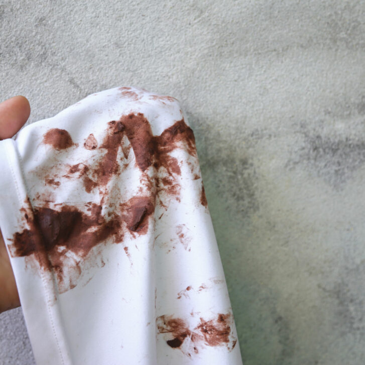 hand showing chocolate stain on clothes