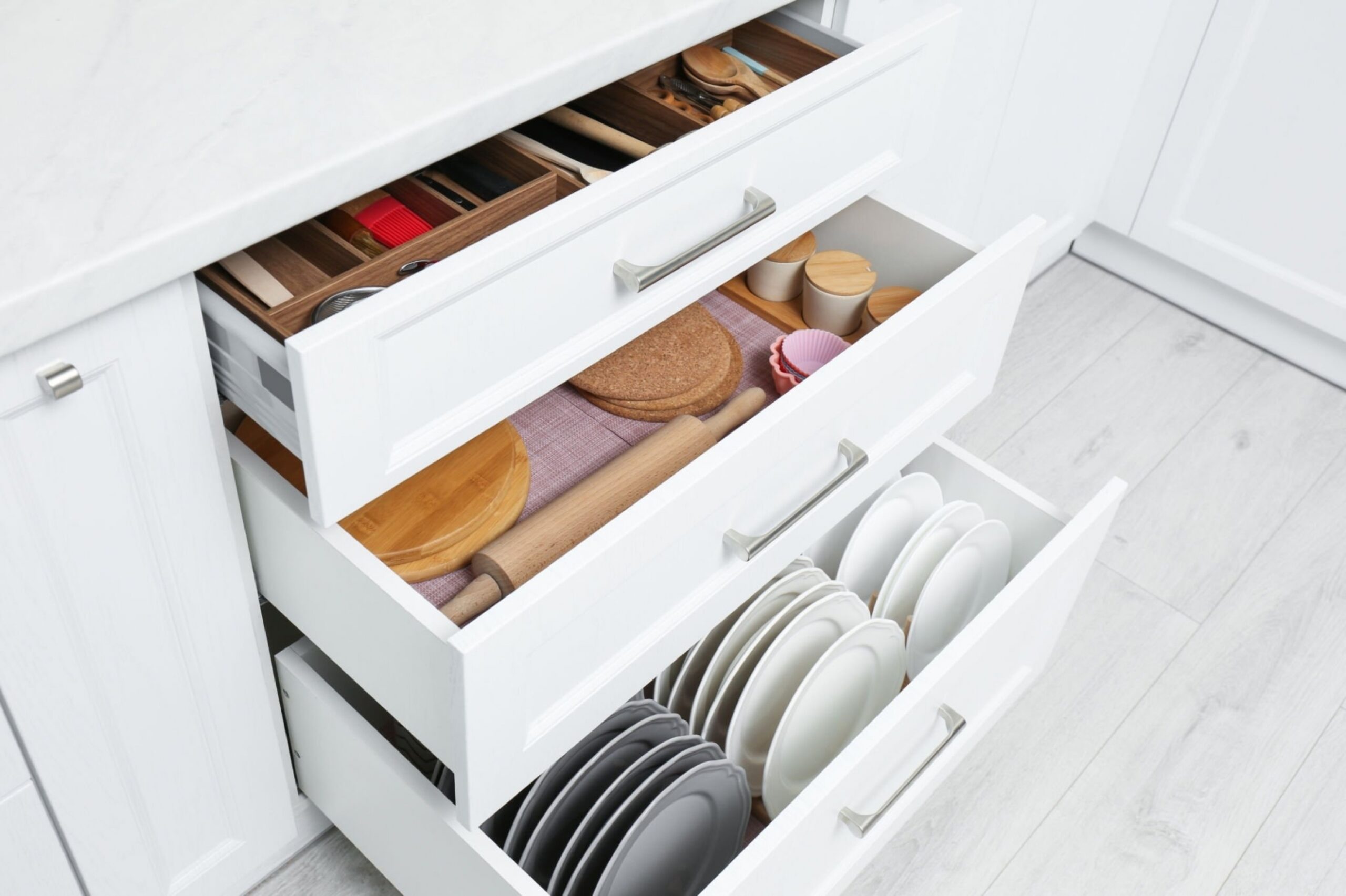 Open drawers with cutlery and utensils
