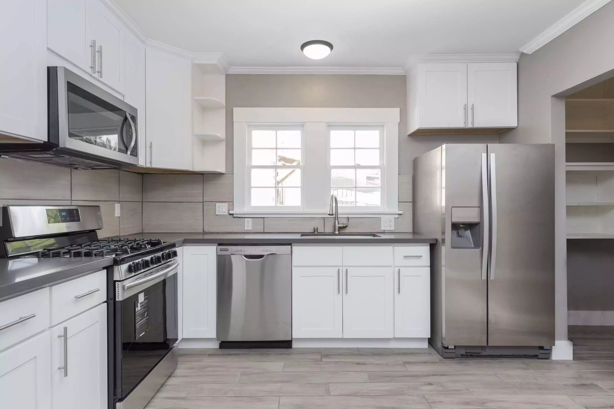 Kitchen with white interior and stainless appliances