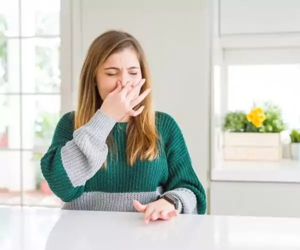 woman reacting to foul smell