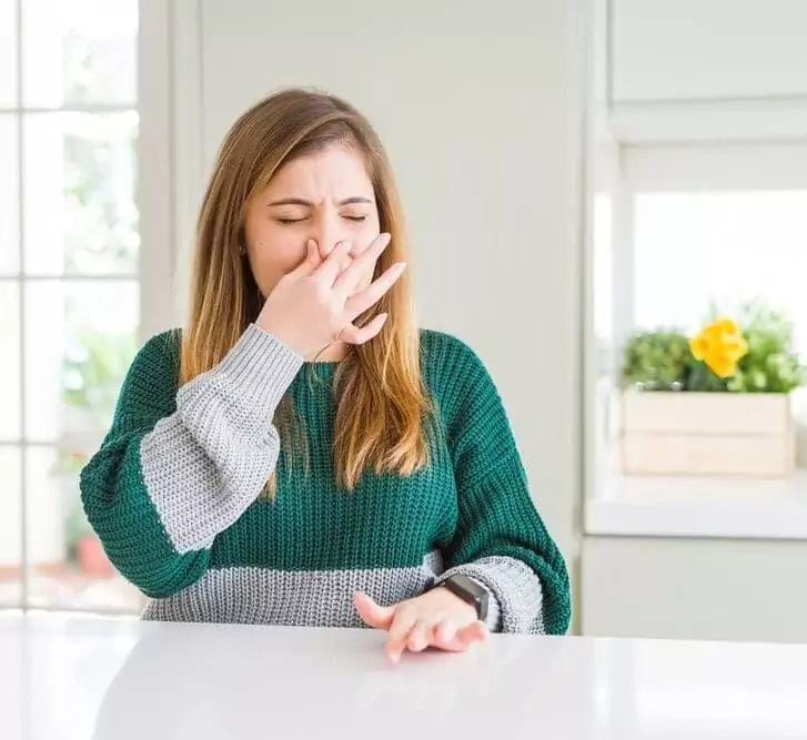 woman reacting to foul smell
