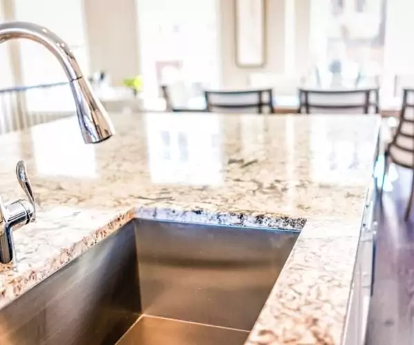 kitchen faucet and sink in granite countertop