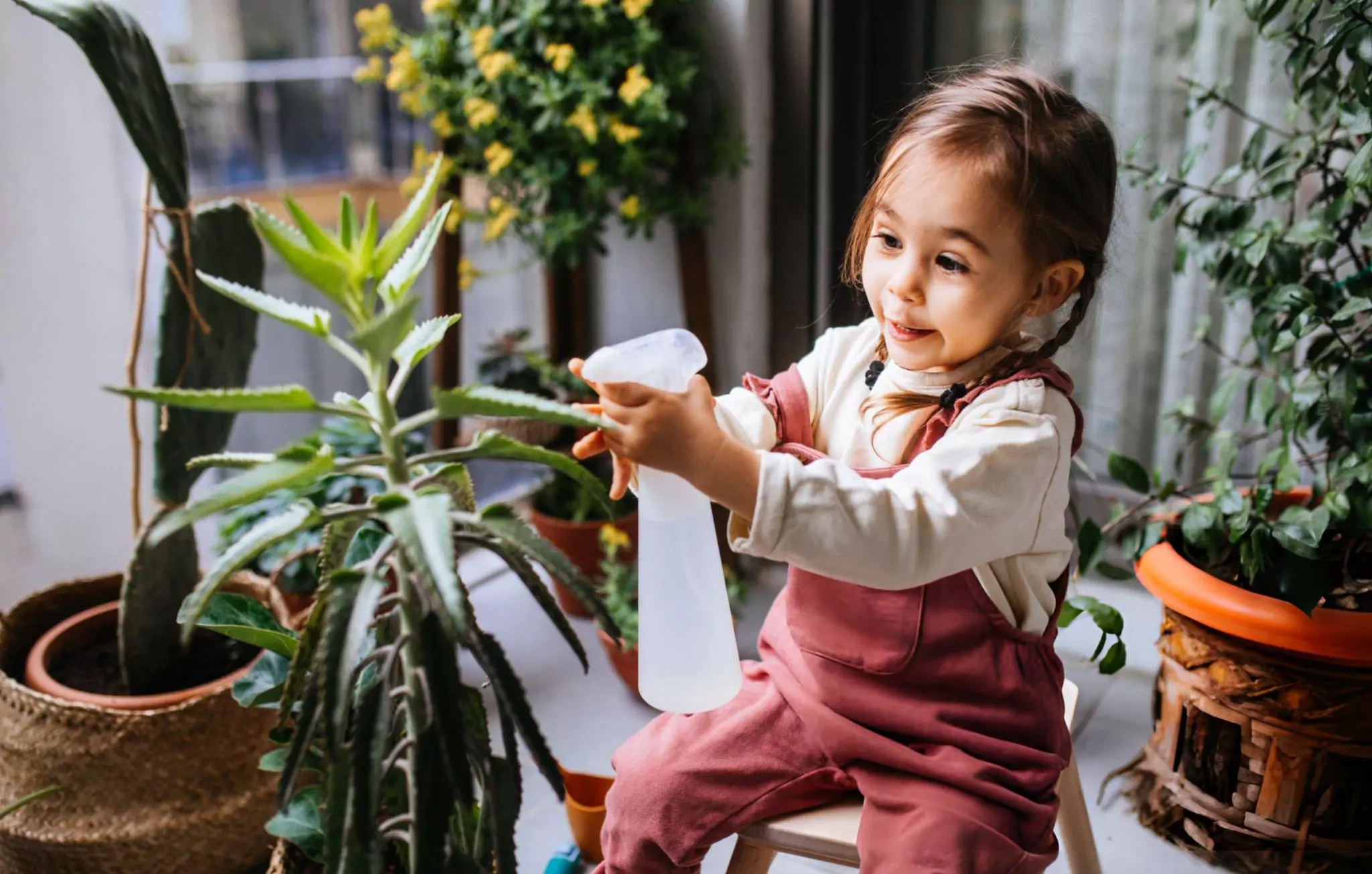 Clean Home Habits Clenzen Image of a Little Girl Watering Houseplants
