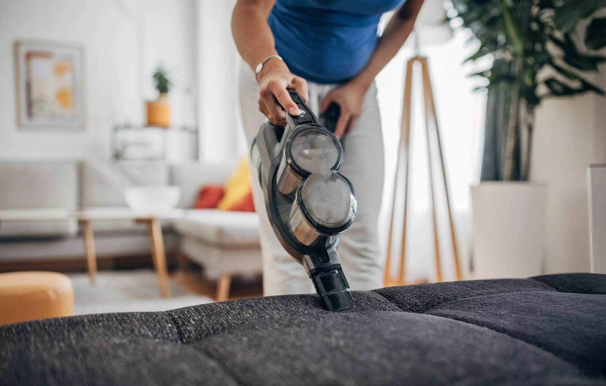 Clean Home Habits Clenzen Image of a Woman Using Hand Held Portable Vacuum Cleaner