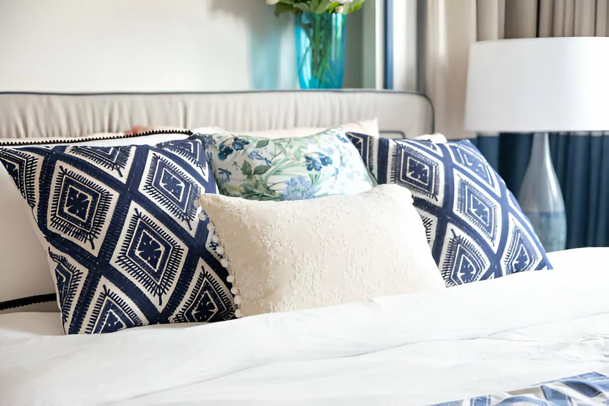 First Apartment Checklist Cleanzen Image of a Mediterranean Style Double Bed with Two Blue Pillows