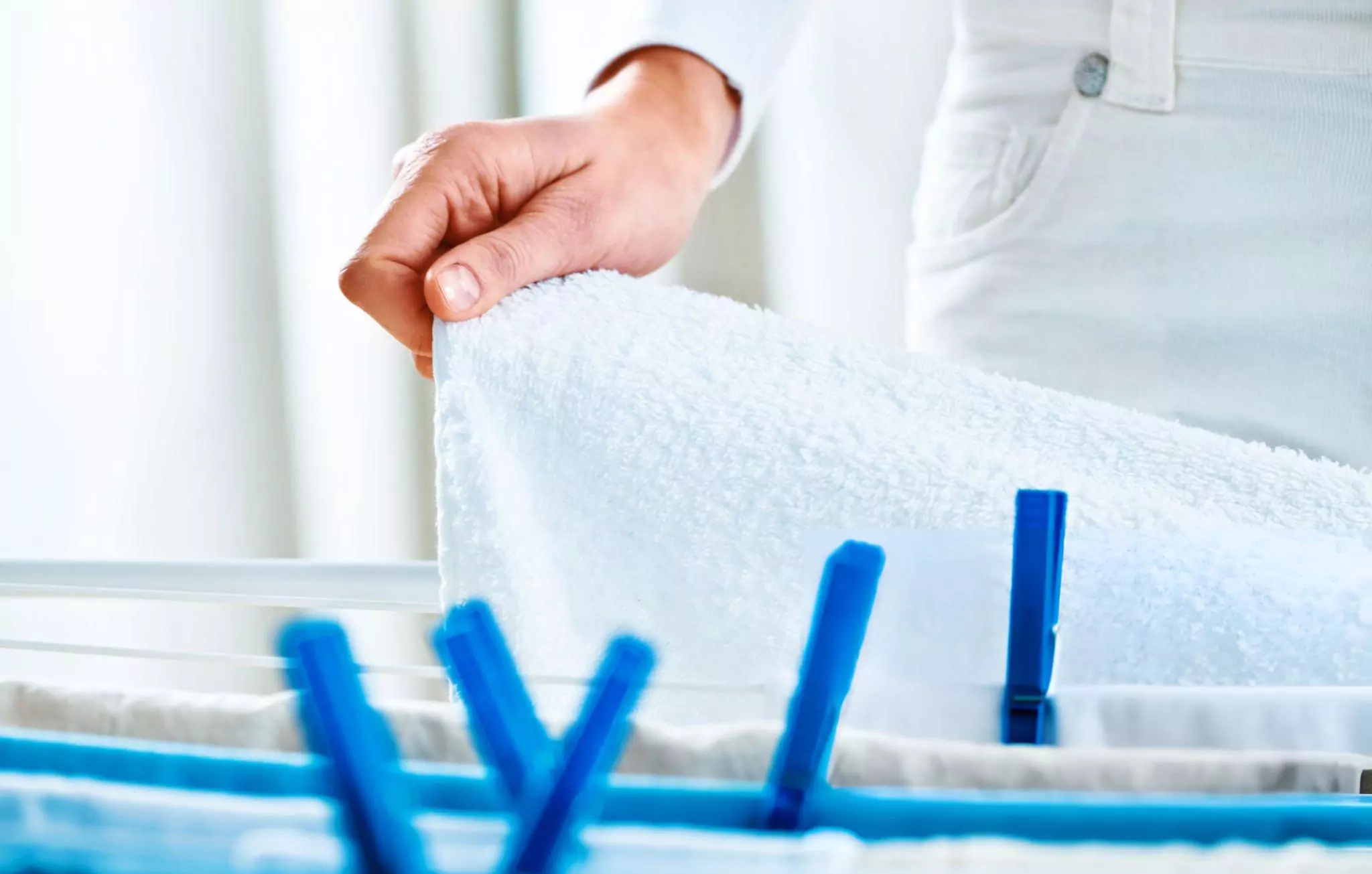 Oxygen Bleach Cleanzen Image of a Woman Hanging Laundry to Dry