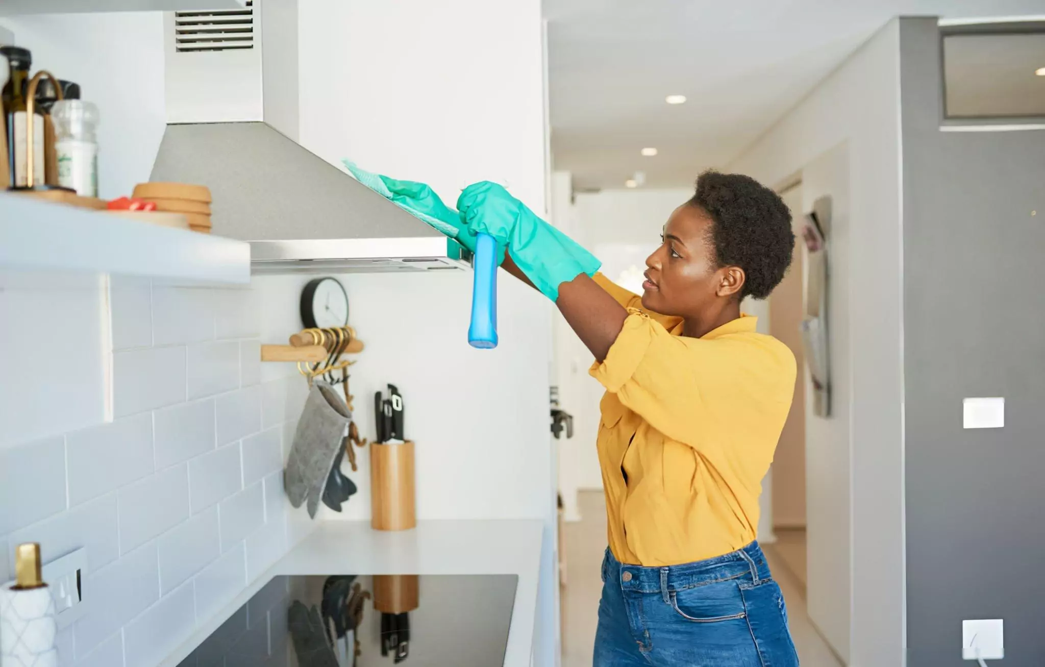 Kitchen Cleaning Checklist Cleanzen Image of a Woman Wiping Kitchen Hood