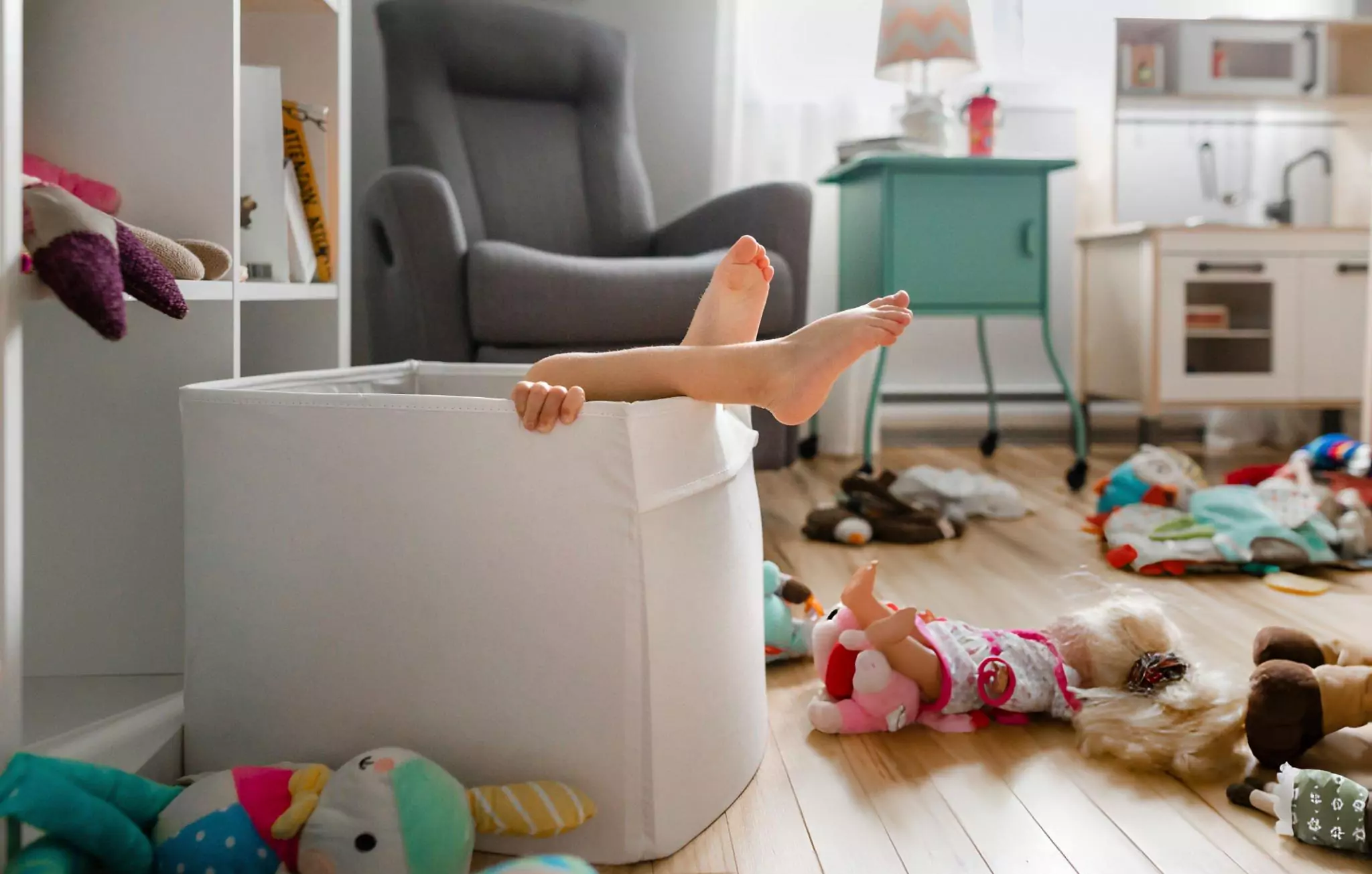 How to Clean Baby Toys Cleanzen Image of a Girl Hiding in Cardboard Box At Home