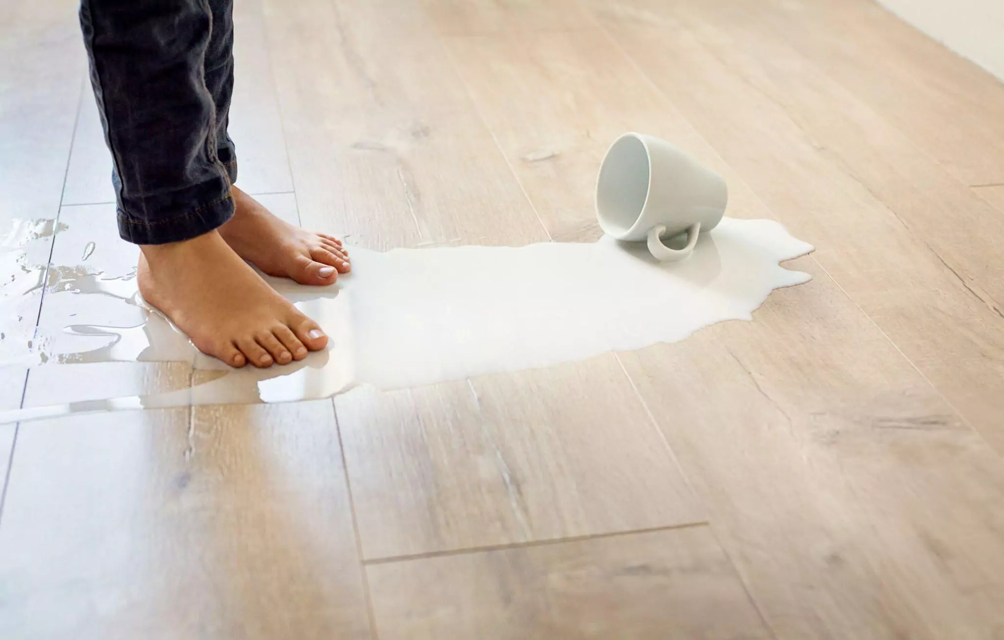 How to Clean Hardwood Floors Cleanzen Image of a Spilled Milk on the Floors
