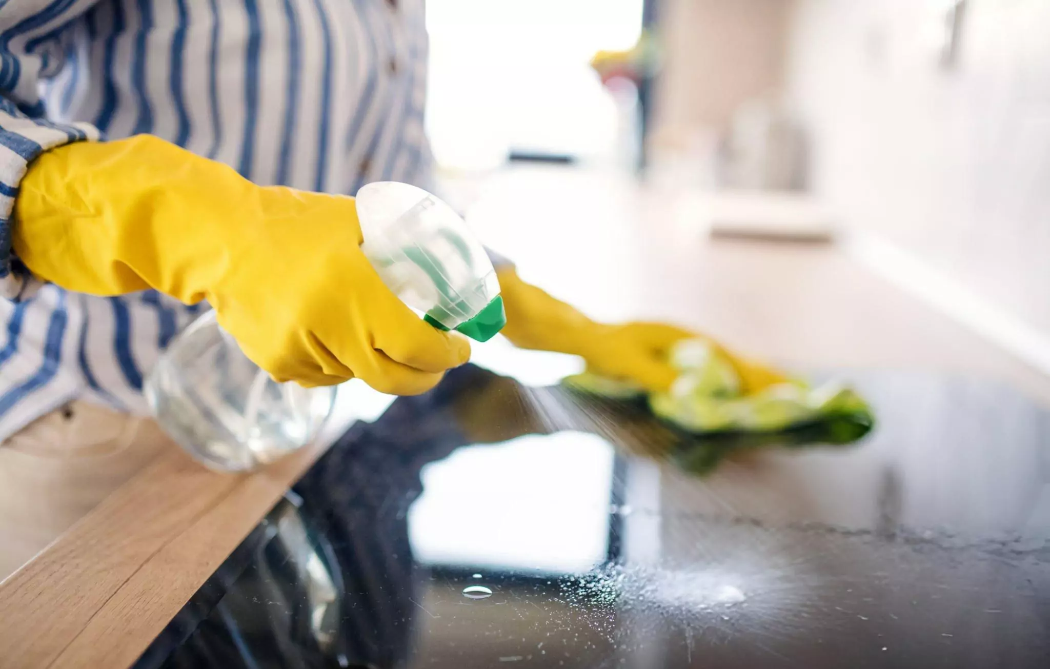 How to Clean a Glass Top Stove Cleanzen Image of a Woman Cleans Glass Stove with Vinegar Cleaner