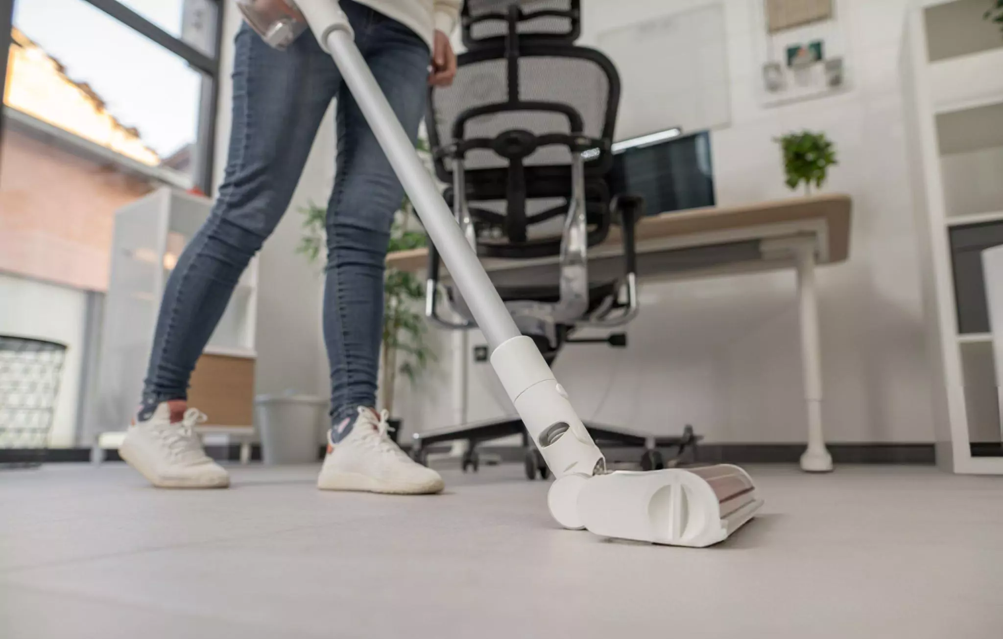How to Keep Your Home Office Clean and Tidy Cleanzen Image of a Woman Vacuuming Home Office Floors