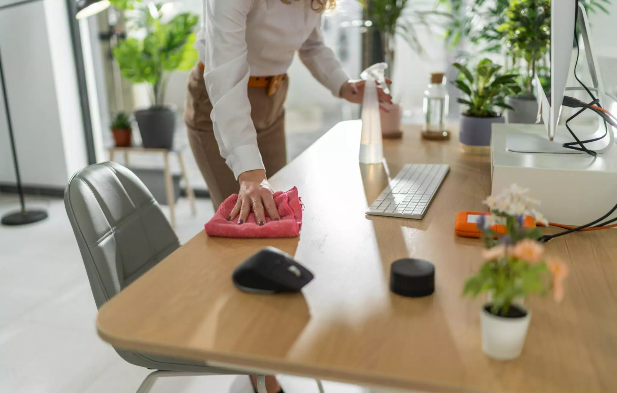 How to Keep Your Home Office Clean and Tidy Cleanzen Image of a Woman Wiping Home Desk