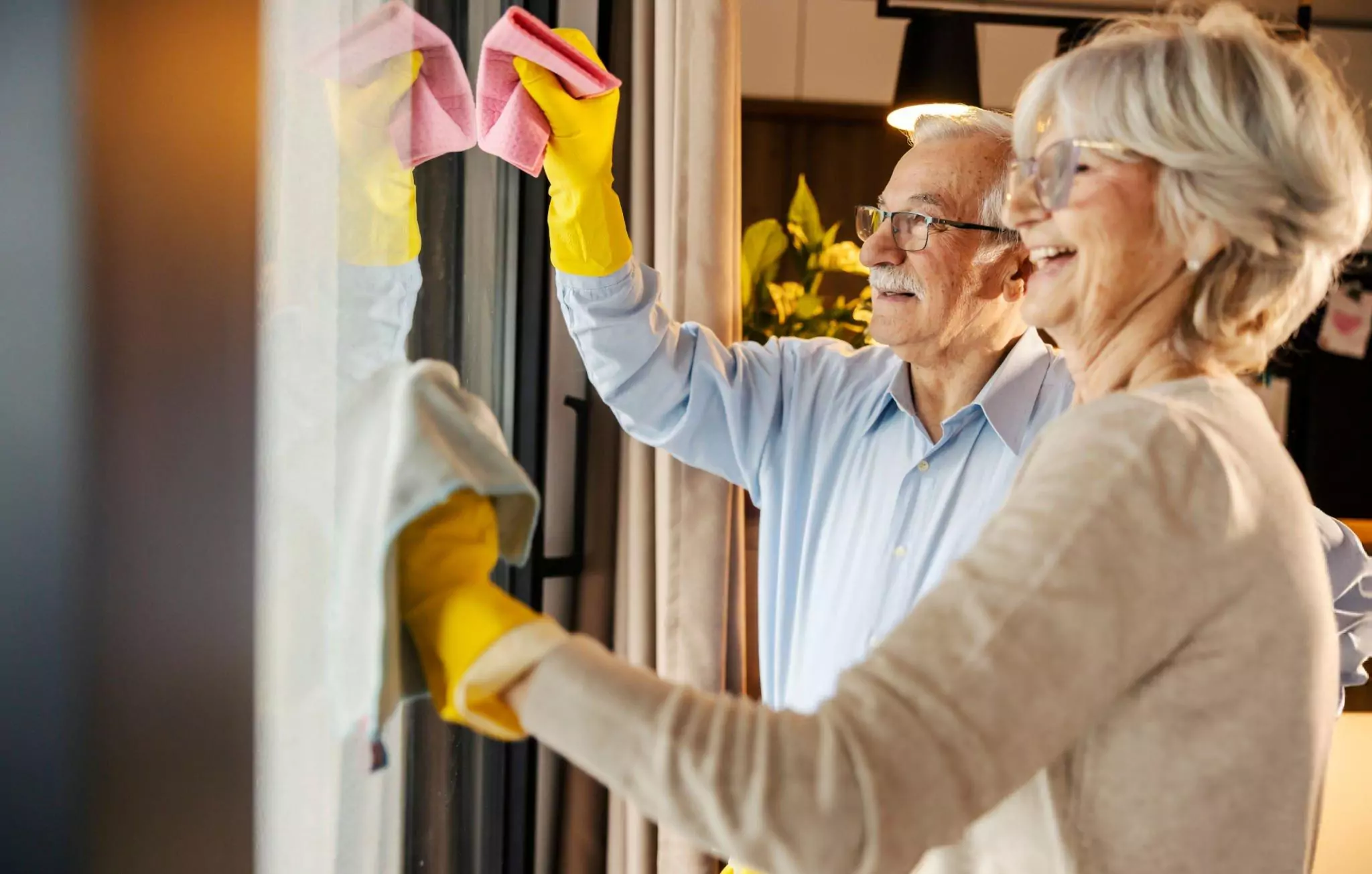 Ways to Help Make Cleaning Easier for Seniors Cleanzen Image of Senior Couple Wiping the Windows