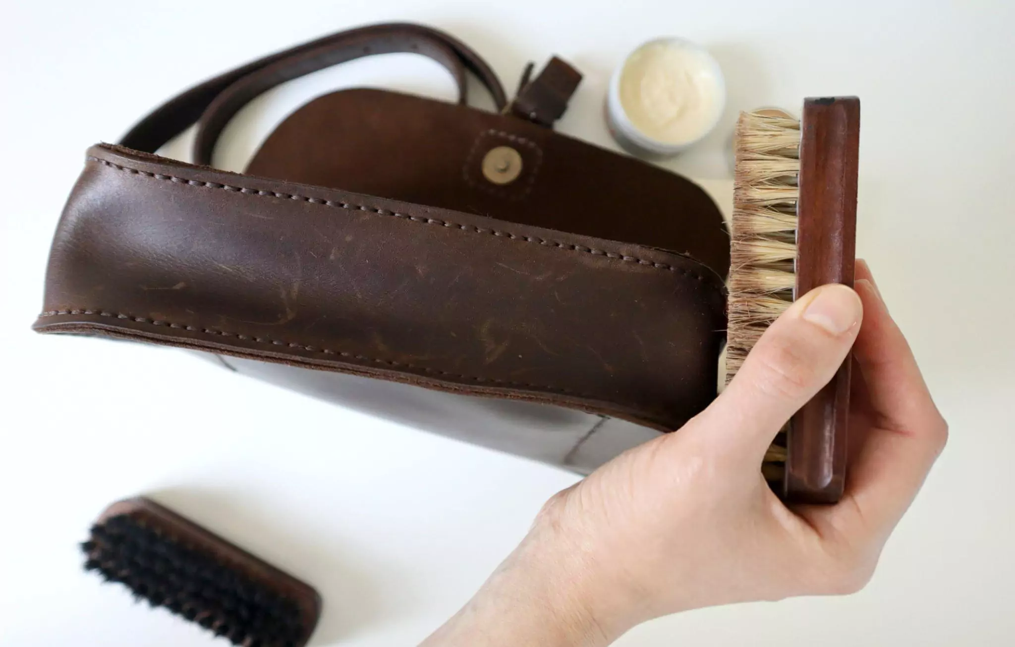 How to Clean Leather Purse Cleanzen Image of a Leather Handbag Being Cleaned and Conditioned