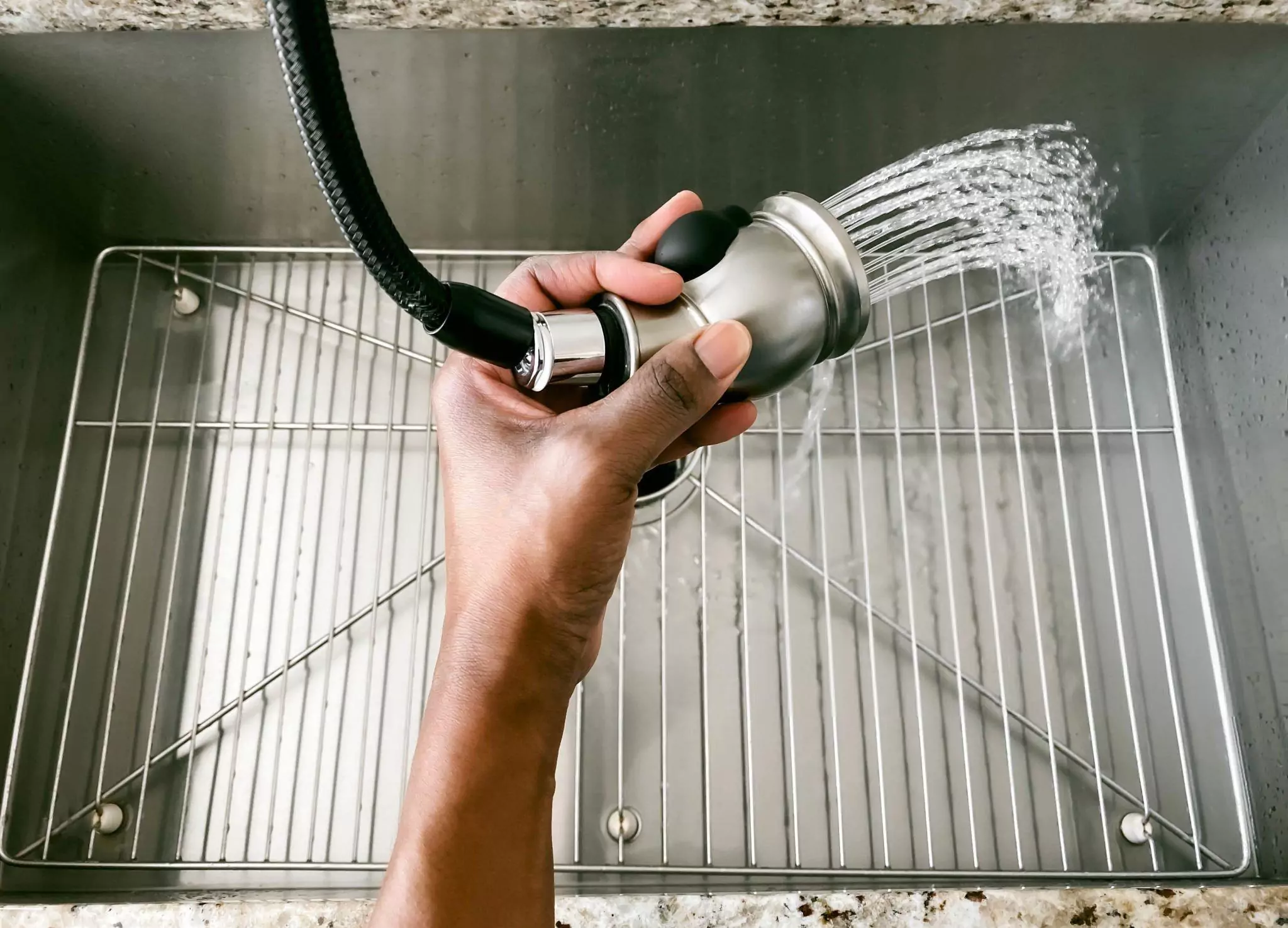 How to Clean Stainless Steel Appliances Cleanzen Image of a Woman Rinses Kitchen Sink