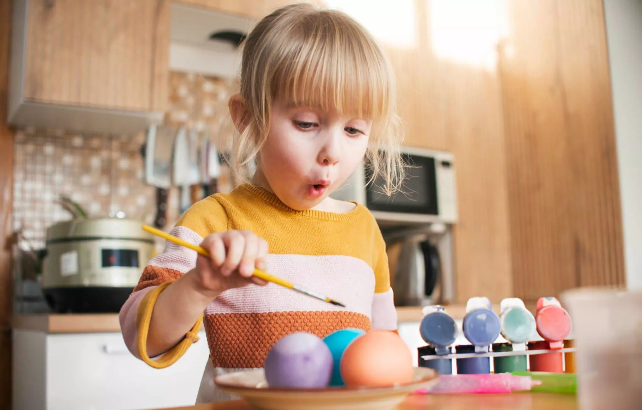 How to Remove Food Coloring Off Counter Cleanzen Image of a Little Girl Adding Color on Eggs