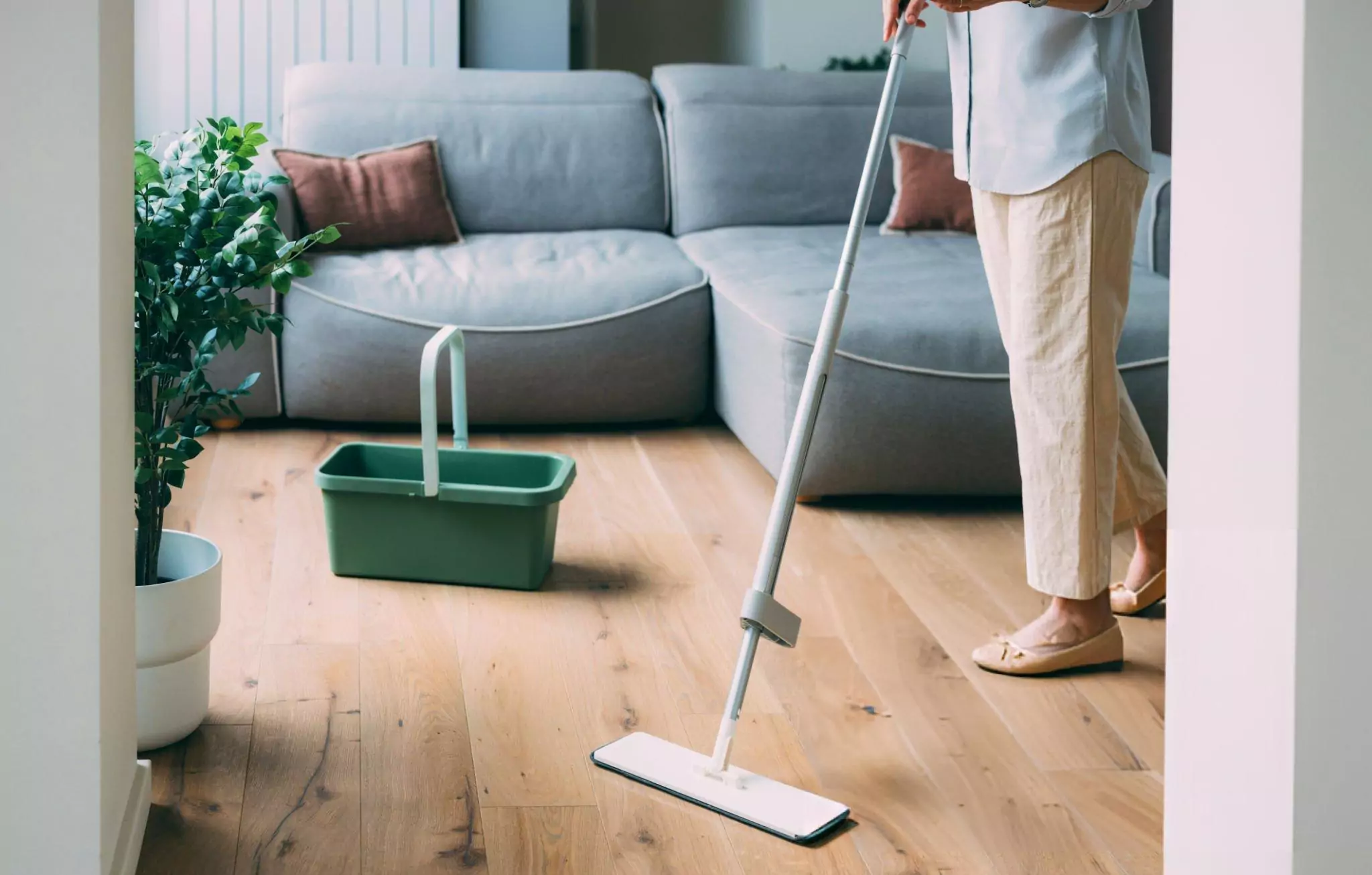Things You Should Never Clean with Vinegar Cleanzen Image of a Person Tidying a Wooden Floor