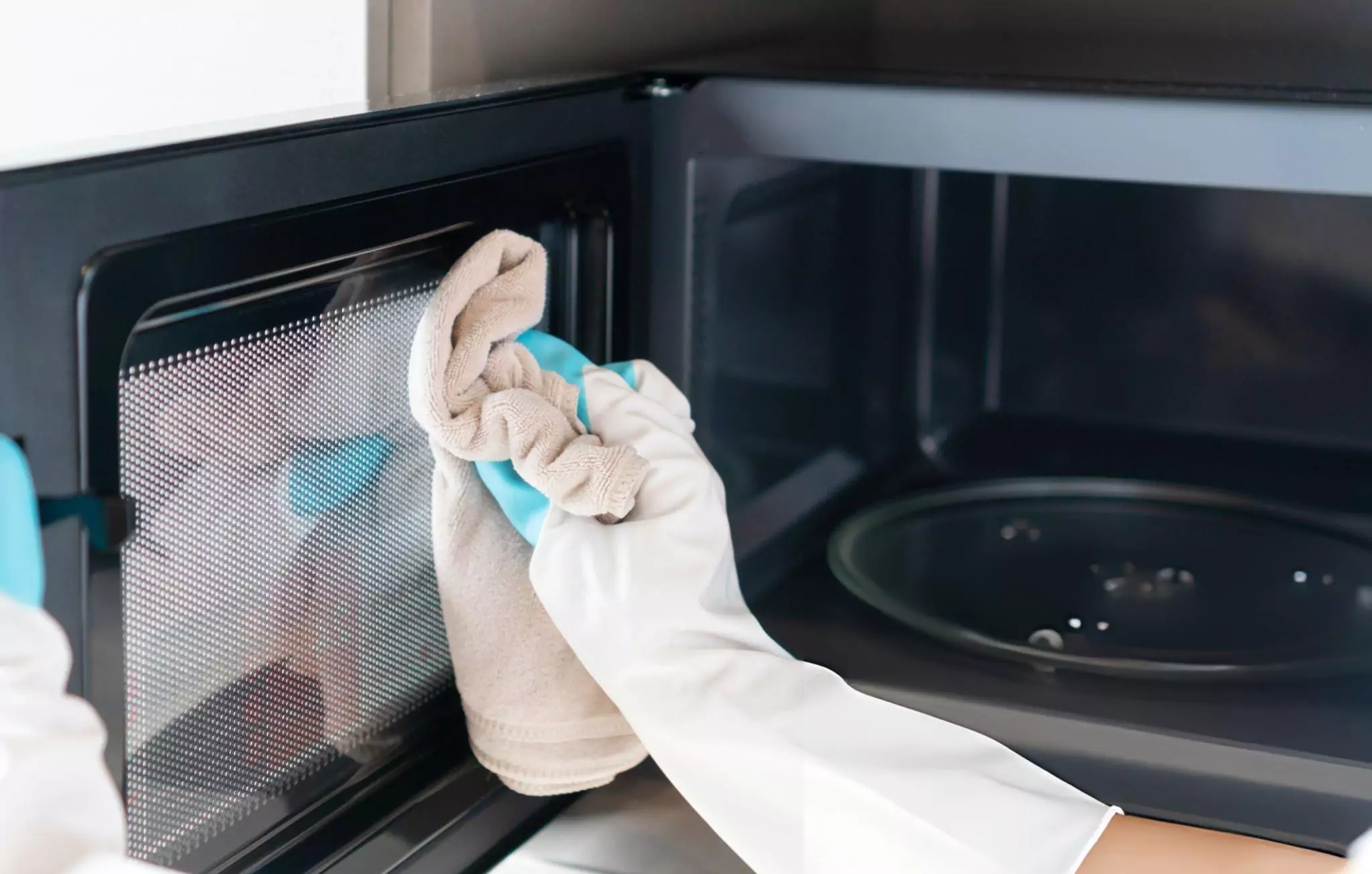 Best Way to Clean a Microwave Cleanzen Image of a Microwave Door Being Wiped