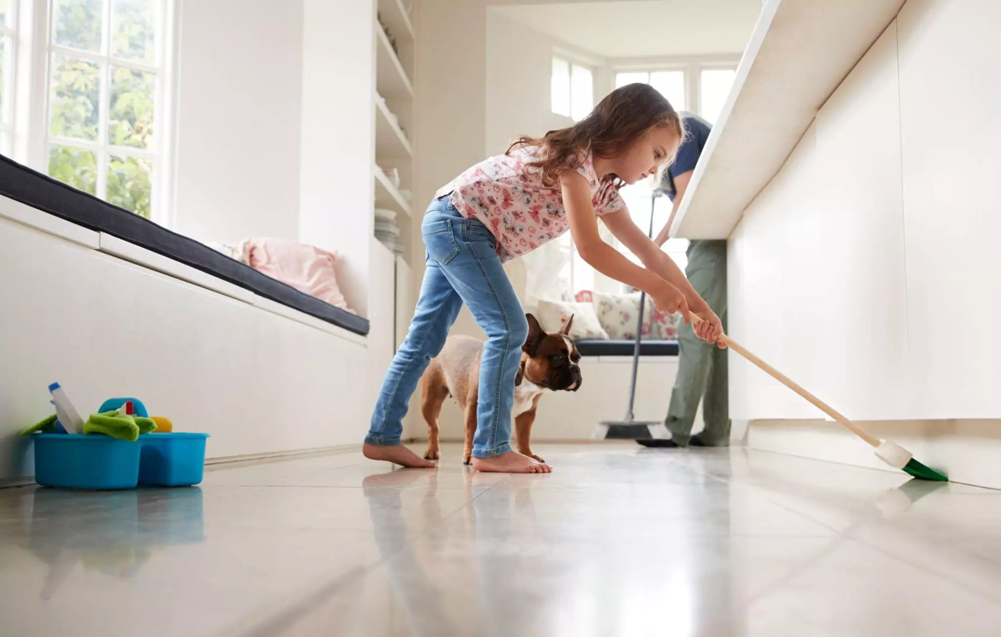 Easy Home Cleaning Resolutions for 2025 Cleanzen Image of Dad and Daughter Sweep the Kitchen Floor Together