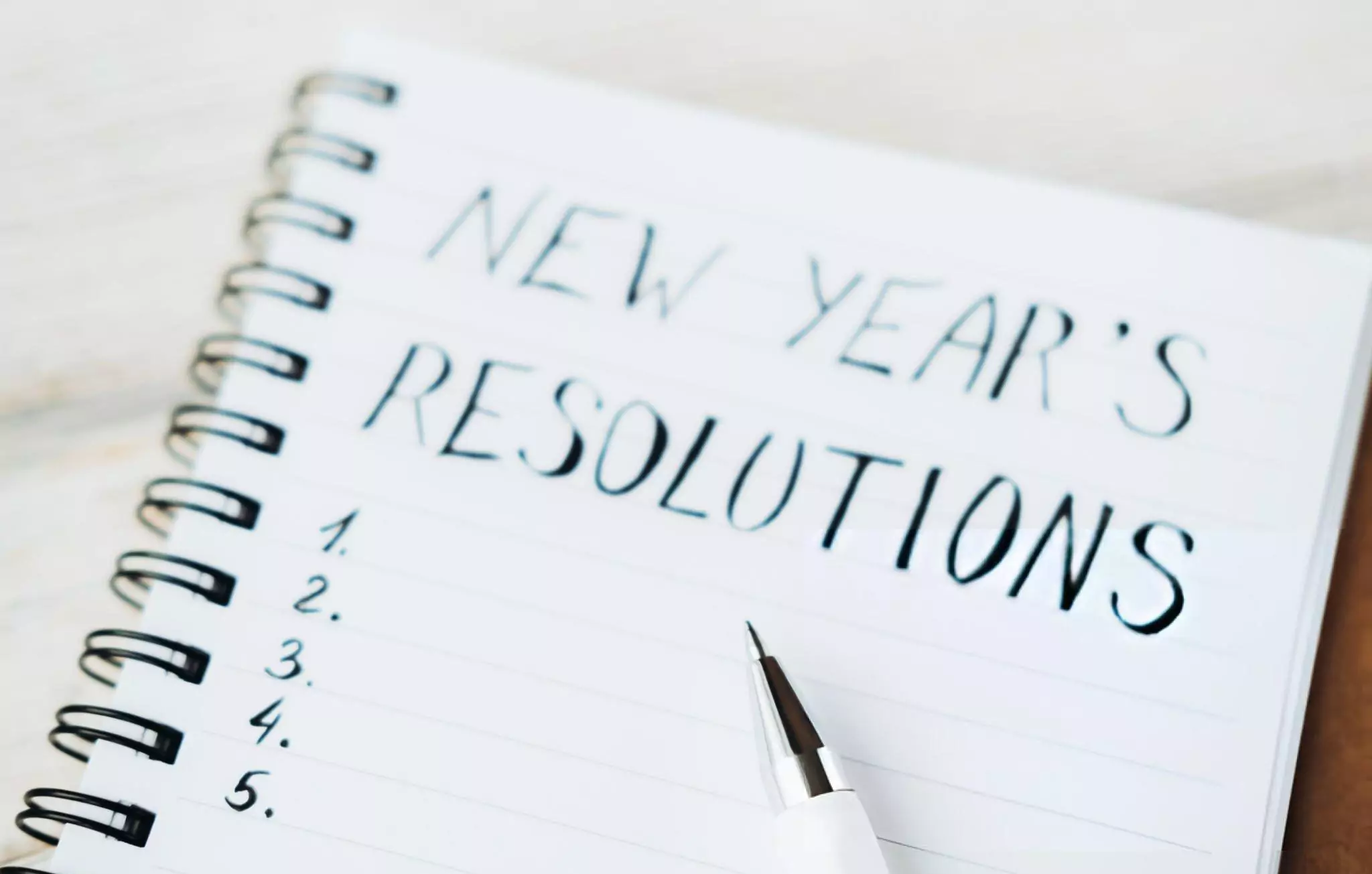 Easy Home Cleaning Resolutions for 2025 Cleanzen Image of New Year's Resolutions on Notepad and a Pen